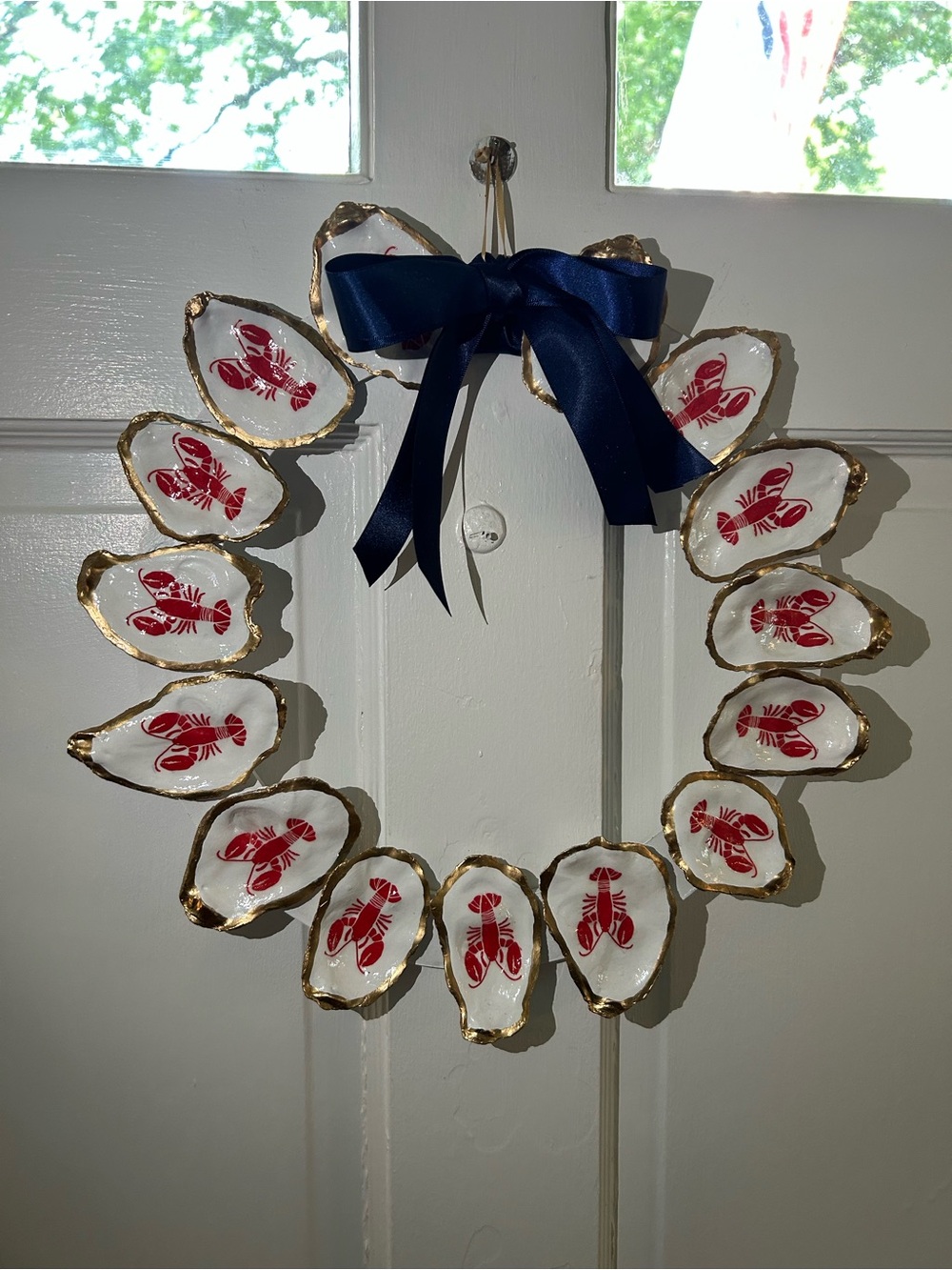 Handcrafted Oyster Shell Wreath with Red Lobster Motif and Navy Bow